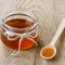 Honey in a spoon and jar on a rustic background 