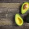 food background with fresh organic avocado on  old wooden table 