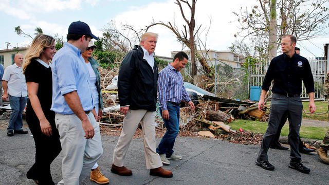 President Trump walks past hurricane wreckage as he visits areas damaged by Hurricane Maria in Guaynabo, Puerto Rico 