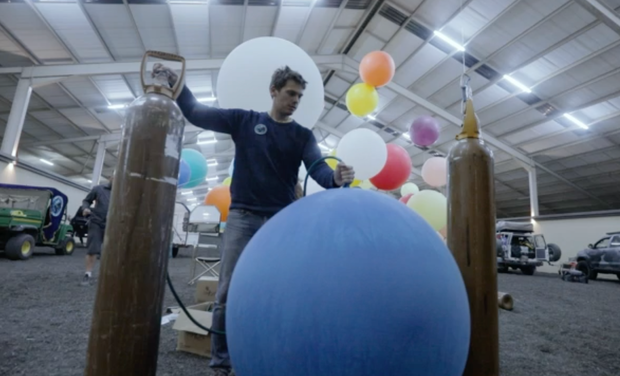 Fearless or foolish man grabs 100 balloons, floats into the sky
