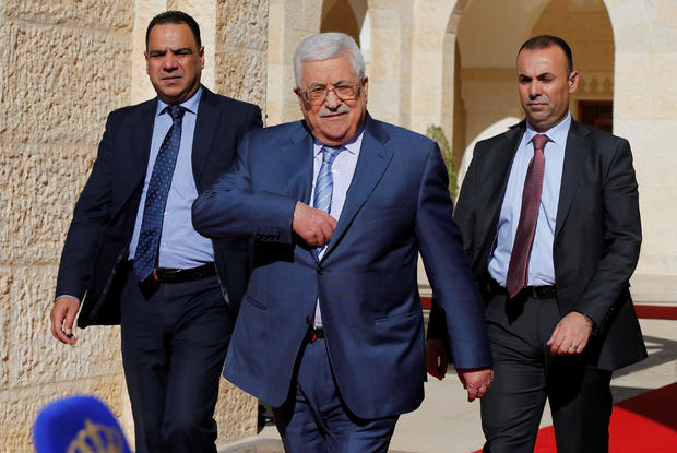 Palestinian President Mahmoud Abbas walks to speaks to the media after his meeting with Jordan's King Abdullah  at the Royal Palace in Amman 
