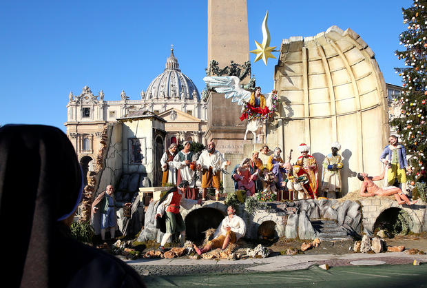 A nun looks at Nativity scene in Saint Peter's square before Pope Francis leads the "Urbi et Orbi" in Vatican 