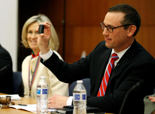Chairman of the Virginia Department of Elections hold up a film canister containing the name of the winner of a random drawing to determine the winner of the 94th House of Delegates District Seat in Richmond, Virginia 