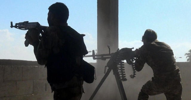 Kurdish fighters face off with Turkish forces in northern Syria