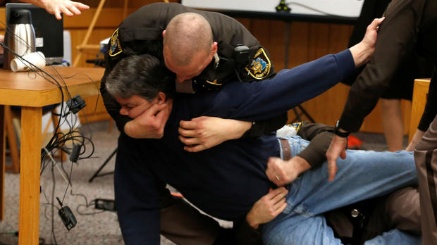 Eaton County sheriff's deputies restrain Randall Margraves after he lunged at Larry Nassar, a former USA Gymnastics team doctor who pleaded guilty in November 2017 to sexual assault charges, during victim statements in his final sentencing hearing in Eaton County Circuit Court in Charlotte, Michigan, Feb. 2, 2018. 