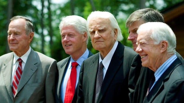 Former Presidents George H.W. Bush, left; Bill Clinton, second left; and Jimmy Carter, right, pose with evangelist Billy Graham and his son Franklin Graham, second right, before the Billy Graham Library dedication on the campus of the Billy Graham Evangelistic Association in Charlotte, North Carolina, May 31, 2007.