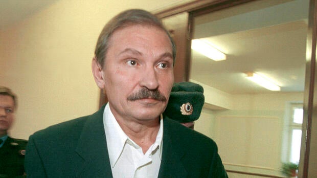 Nikolai Glushkov, ex-deputy director general of flagship Russian airline Aeroflot, leaves court escorted by police officers after a judge refused to release him on bail in Moscow Dec. 19, 2000.