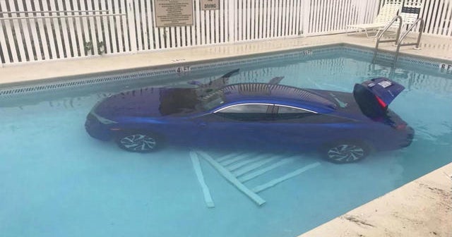 Car rolls into pool with father and daughter inside CBS News