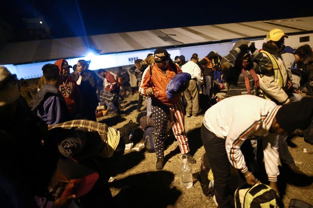 Central American migrants, moving in a caravan through Mexico, wait next to a railway line before embarking on a new leg of their travels, in Tlaquepaque