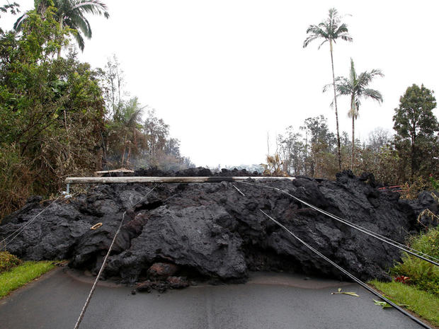 Lava and downed power lines block a road in the Leilani Estates subdivision during ongoing eruptions of the Kilauea Volcano 
