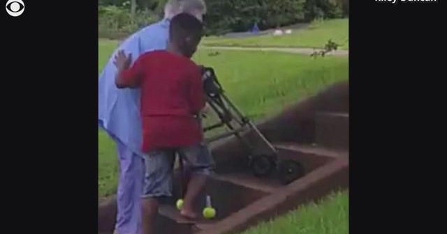 Boy helps elderly woman struggling to walk up stairs CBS