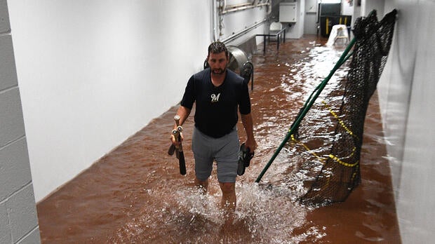 Marcus Hanel, No. 55 of the Milwaukee Brewers, walks through a flooded hallway outside of the dugout during a rain delay in a game against the Pittsburgh Pirates at PNC Park on June 20, 2018, in Pittsburgh, Pennsylvania.
