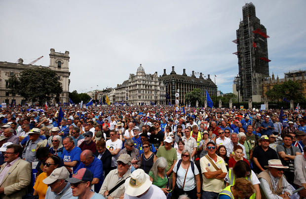 EU supporters, calling on the government to give Britons a vote on the final Brexit deal, listen to a speaker in Parliament Square, after participating in the 'People's Vote' march in central London 