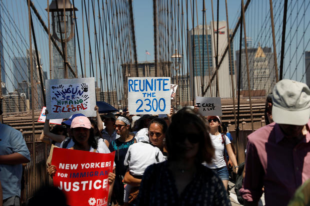 Demonstrators march on Brooklyn Bridge during "Keep Families Together" march to protest Trump administration's immigration policy in New York 