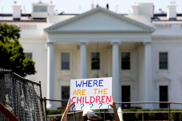 An immigration activists hold signs against family separation during a rally to protest against the Trump Administration's immigration policy outside the White House in Washington 