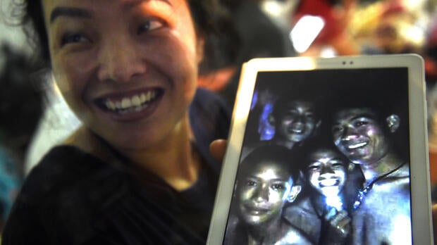 A happy family member shows members of a boys soccer team found by rescue divers inside Tham Luang cave after the team and their coach went missing for over a week at Khun Nam Nang Non Forest Park in Chiang Rai, Thailand, July 2, 2018.