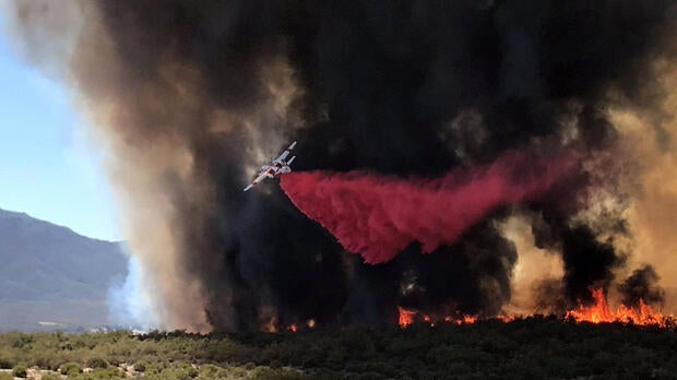 An air tanker drops retardant on the so-called Benton Fire near the intersection of Benton Road and Crams Corner Drive in this image on social media in Anza California