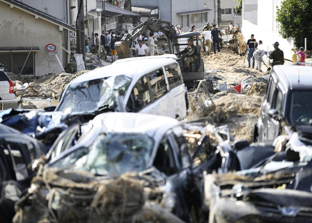   People clean up debris from torrential rains at Aki district in Hiroshima 