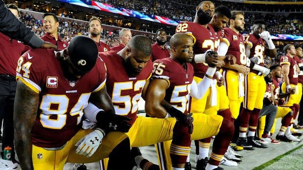Washington Redskins tight end Niles Paul (84), linebacker Ryan Anderson (52) and linebacker Chris Carter (55) kneel with teammates during the playing of the national anthem before a game against the Oakland Raiders at FedEx Field in Landover, Maryland, on