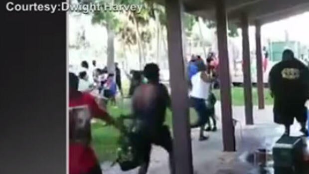 In this still from video posted on social media, people race for cover as a gunman opens fire Aug. 4, 2018, at a peace rally in Titusville, Florida.