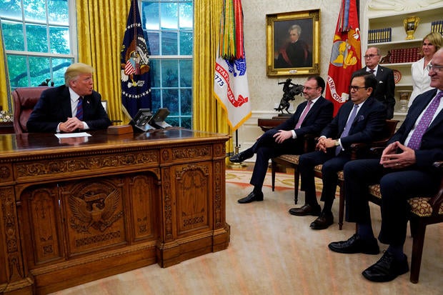 Mexican trade representatives look on as Trump announces deal on NAFTA at the White House in Washington