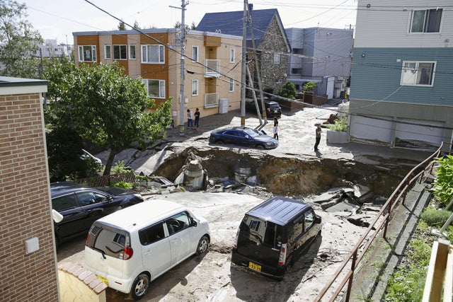 People look at an area damaged by an earthquake in Sapporo 
