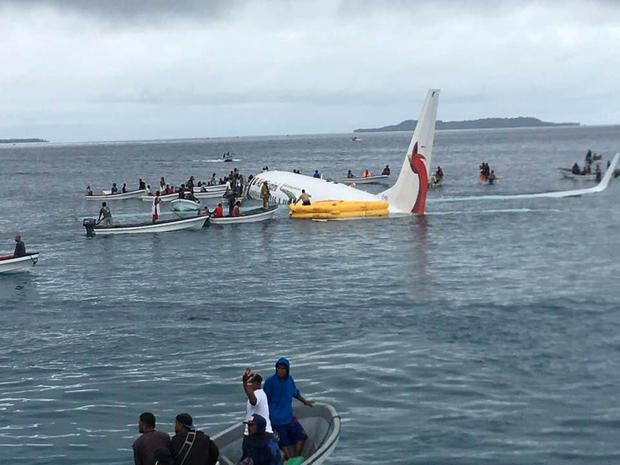 People are evacuated from an Air Niugini plane crashed in the waters in Weno, Chuuk, Micronesia 