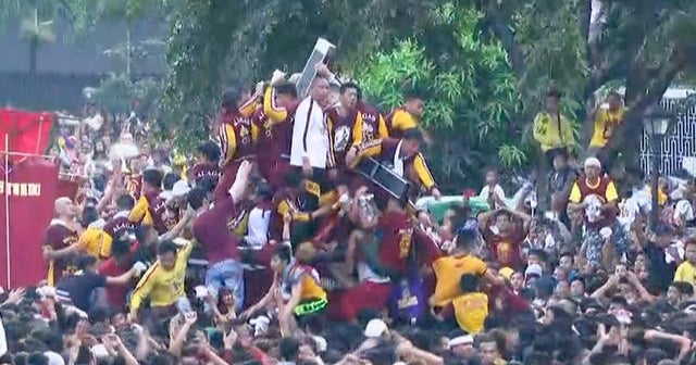Watch: Filipino Catholics climb onto statue of Jesus