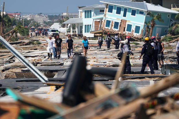 First responders and residents walk along a main street following Hurricane Michael in Mexico Beach 