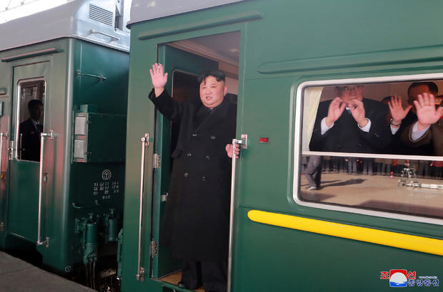 North Korean leader Kim Jong Un waves from a train as he departs for a summit in Hanoi 