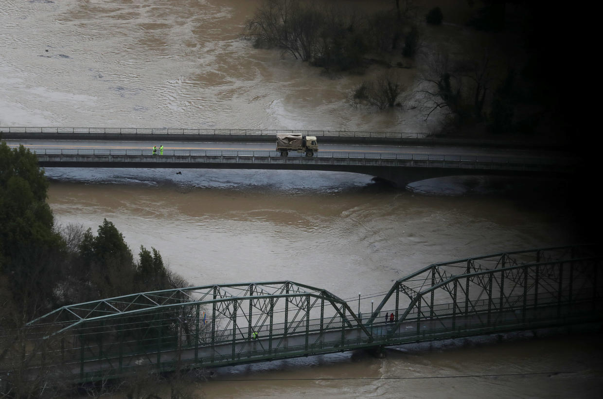 California town trapped by flood waters after river overflows CBS News