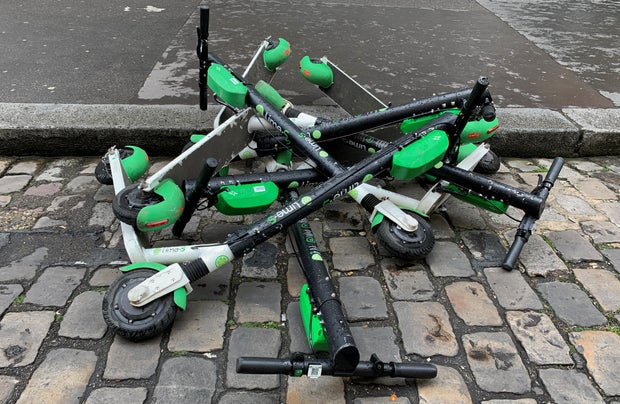 Dock-free electric scooters Lime-S by California-based bicycle sharing service Lime are stacked on Parisian cobblestones in a street of Paris