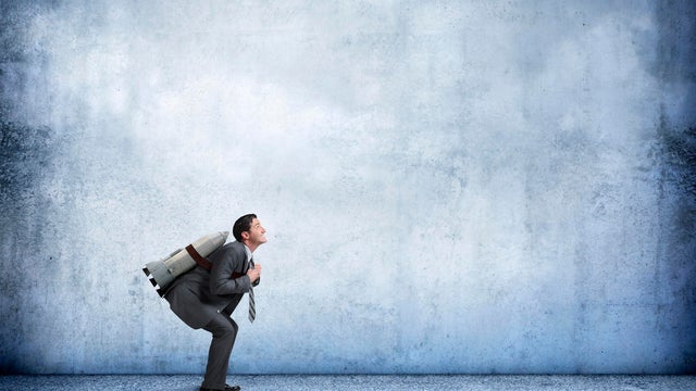 Businessman With Rocket Strapped To His Back 