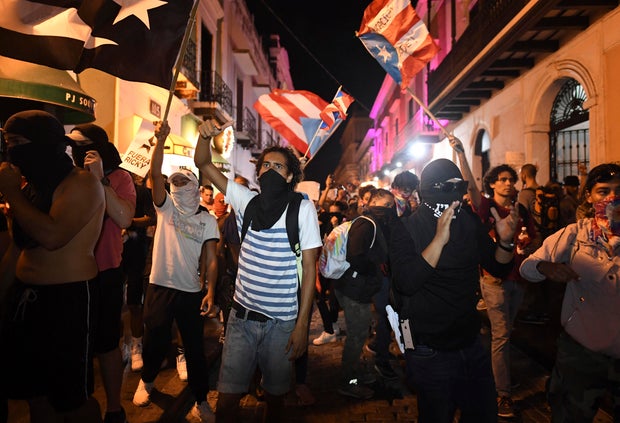Protesters call for Puerto Rico Gov. Ricardo Rosselló's ouster outside his official residence in the heart of San Juan.
LUIS ALCALA DEL OLMO AP