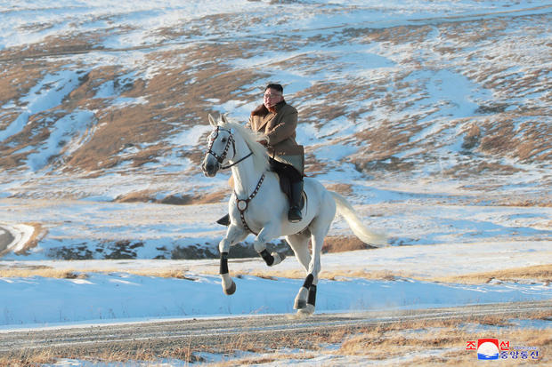North Korean leader Kim Jong Un rides a horse during snowfall in Mount Paektu 