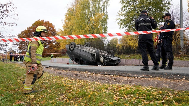 An overturn car is seen on the road, after it was allegedly struck by an ambulance which was stolen by an armed man in Oslo
