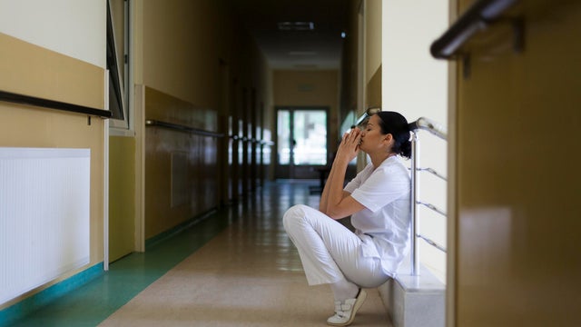 Young arab doctor surgeon woman over isolated background afraid and terrified with fear expression stop gesture with hands, shouting in shock. Panic concept.