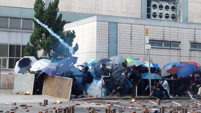 Protesters are detained by riot police while attempting to leave the campus of Hong Kong Polytechnic University (PolyU) during clashes with police in Hong Kong 