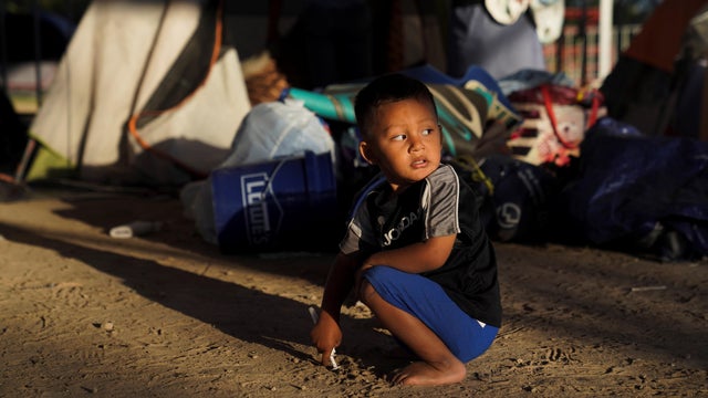 An asylum-seeking child plays in an encampment where he lives in Matamoros