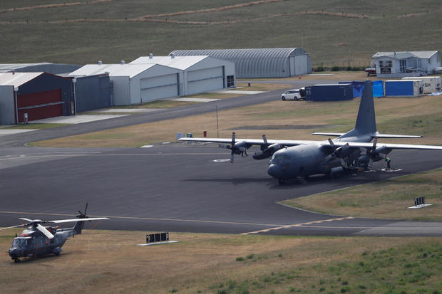 A military plane and helicopter are seen at the airport in Whakatane 
