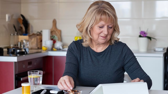 Senior diabetic woman preparing a breakfast  at home 