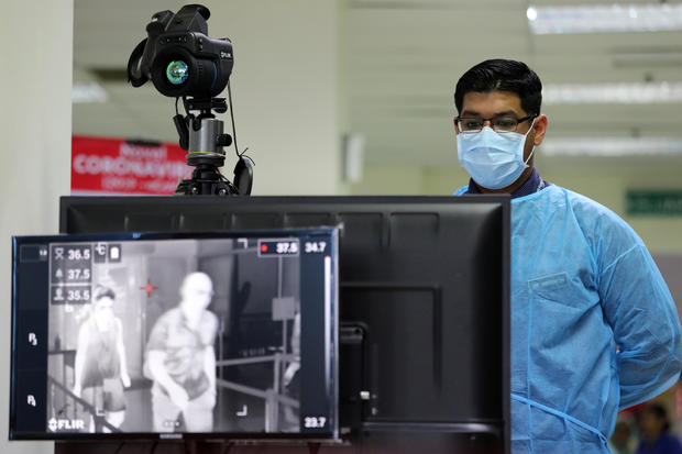 A Malaysian health quarantine officer waits for passengers at a thermal screening point at a cruise ship terminal, following the outbreak of the coronavirus in China, in Port Klang 