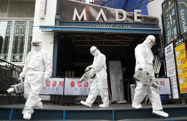 Quarantine worker spray disinfectants in front of a night club on the night spots in the Itaewon neighborhood, following the coronavirus disease (COVID-19) outbreak, in Seoul 