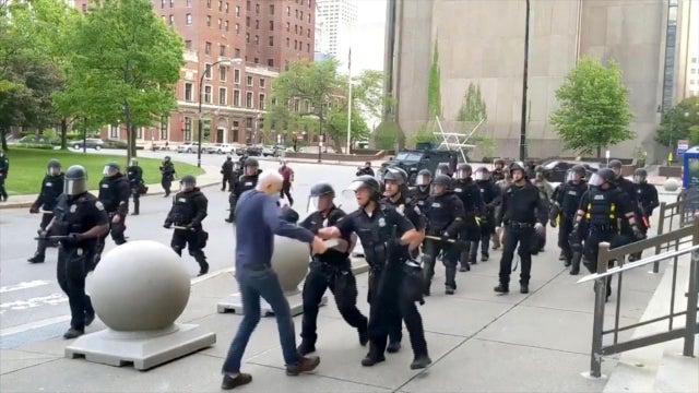 An elderly man appears to be shoved by riot police during a protest over the death of George Floyd in Buffalo, New York, on June 4, 2020, in this still image taken from video. 