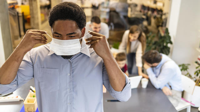 Adult man wearing a pollution mask to protect himself from viruses 