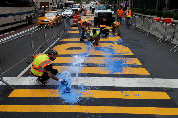 Protesters throw paint on a Black Lives Matter mural outside of Trump Tower on Fifth Avenue in Manhattan, New York 