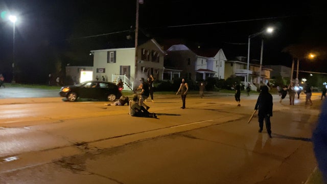A man is being shot in his arm during a protest following the police shooting of Jacob Blake, a Black man, in Kenosha 