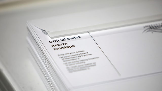 Poll workers prepare absentee ballots for the general election in Raleigh