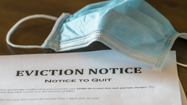 Official legal eviction order or notice to renter or tenant of home with face mask 