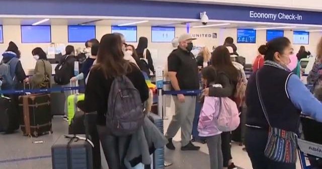 Millions pack airports, roads despite warnings from health experts